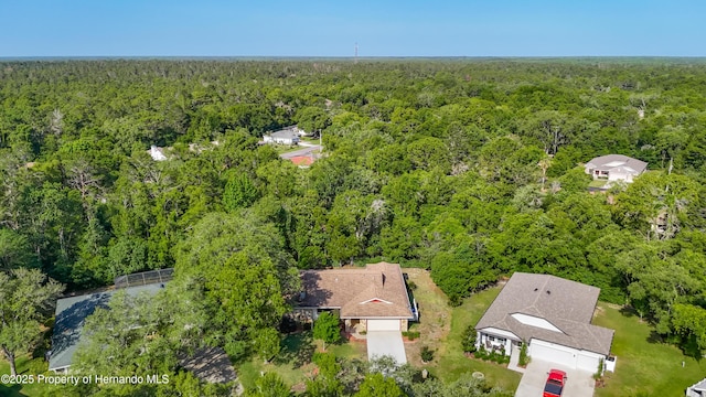 birds eye view of property with a wooded view