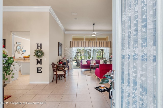 foyer with crown molding, light tile patterned flooring, and baseboards