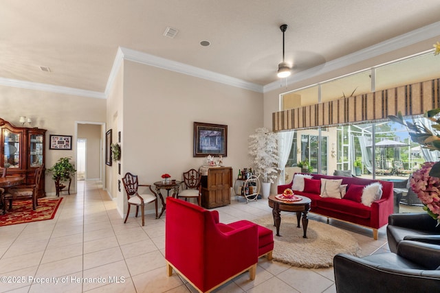 living room with light tile patterned floors, crown molding, ceiling fan, and visible vents