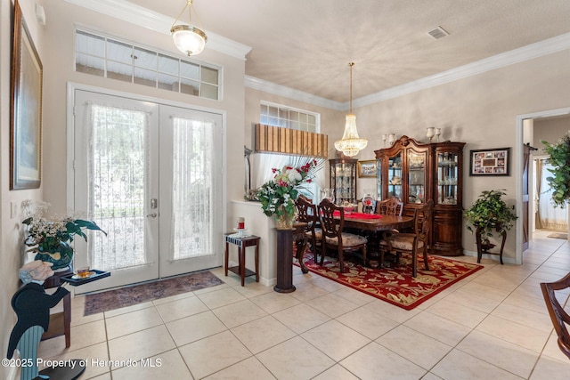 tiled dining room with french doors, plenty of natural light, and visible vents