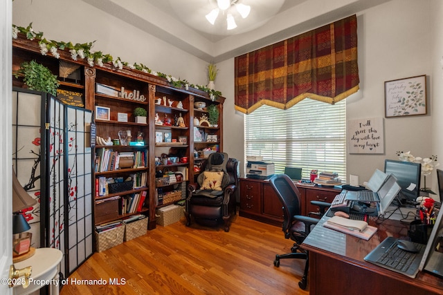 office area with a ceiling fan and wood finished floors