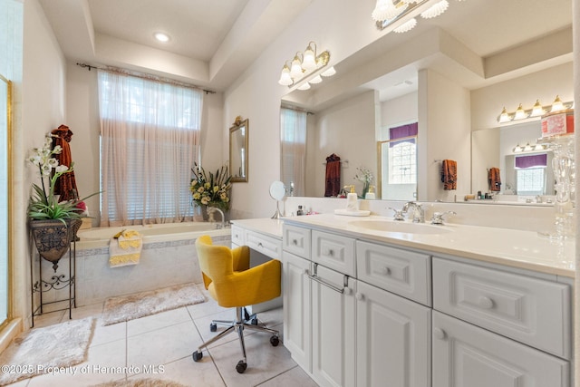 full bathroom with tile patterned flooring, a bath, and vanity