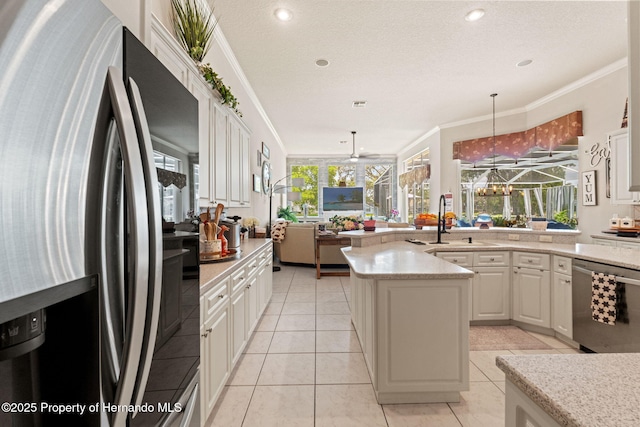 kitchen with white cabinetry, appliances with stainless steel finishes, and ornamental molding