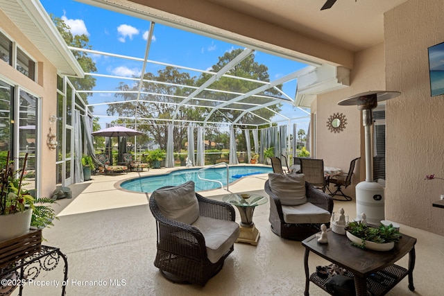 pool featuring ceiling fan, a patio area, and a lanai