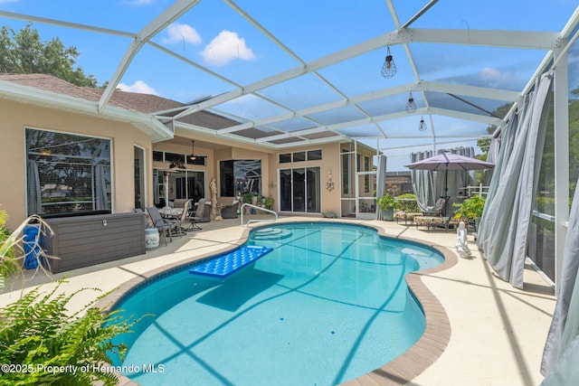 pool featuring a ceiling fan, a lanai, and a patio area