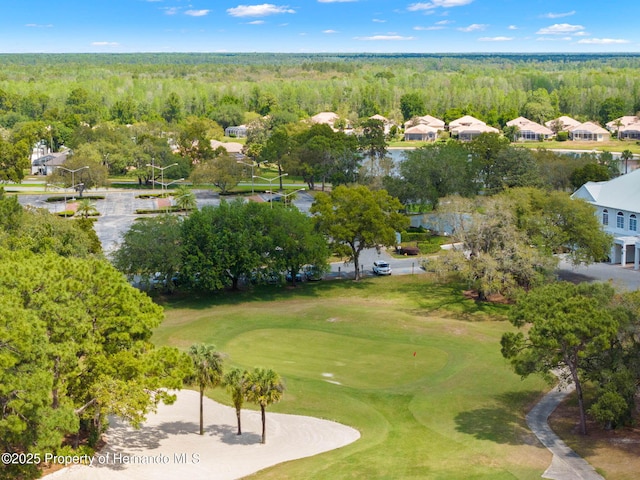 birds eye view of property featuring golf course view and a forest view