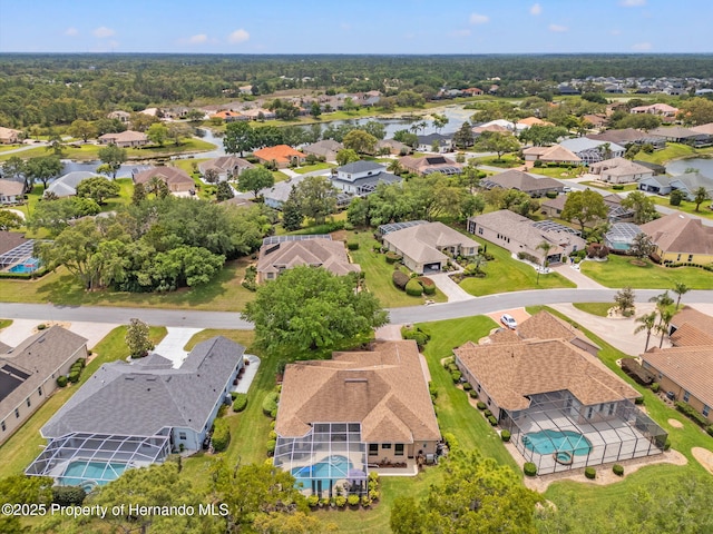 birds eye view of property with a water view and a residential view
