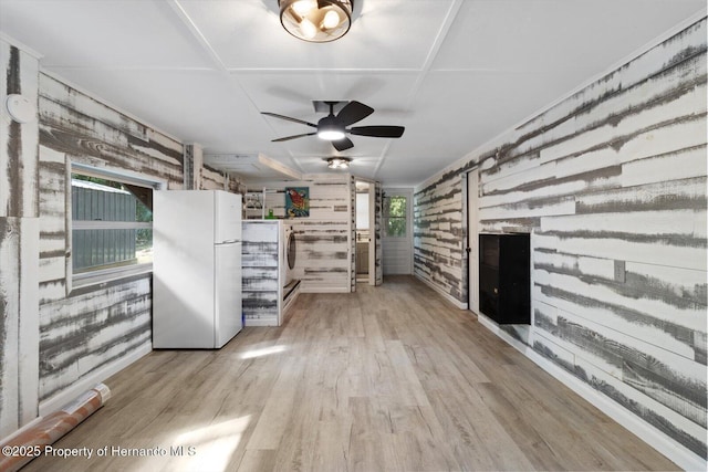 6373 E River Rd, Hernando, FL 34442 - interior space with wood walls, a ceiling fan, light wood-type flooring, and washer / clothes dryer