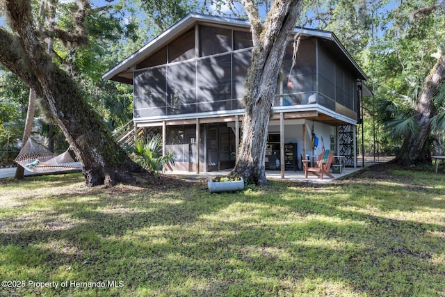 6373 E River Rd, Hernando, FL 34442 - rear view of property with a yard, a sunroom, and a patio area