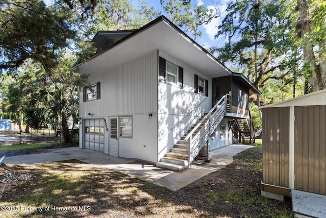6373 E River Rd, Hernando, FL 34442 - view of home's exterior with stairs, an attached garage, and concrete driveway