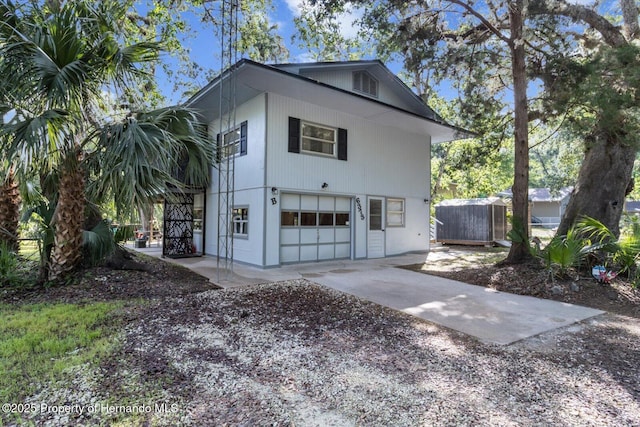 6373 E River Rd, Hernando, FL 34442 - view of side of home featuring fence, driveway, and a garage
