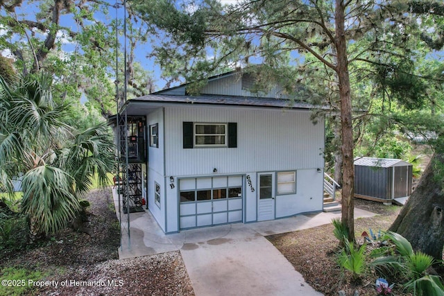 6373 E River Rd, Hernando, FL 34442 - view of shed with stairs, an attached garage, and driveway