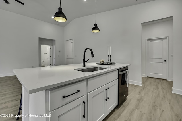 kitchen with an island with sink, light wood-type flooring, white cabinets, a sink, and dishwasher