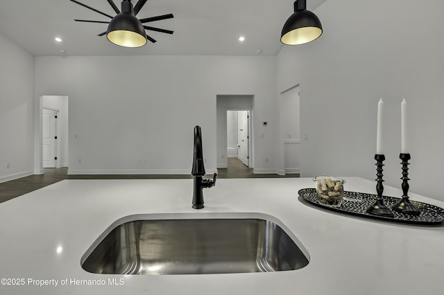 details featuring recessed lighting, a sink, a ceiling fan, and wood finished floors