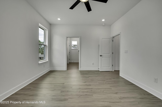 interior space featuring recessed lighting, baseboards, and wood finished floors