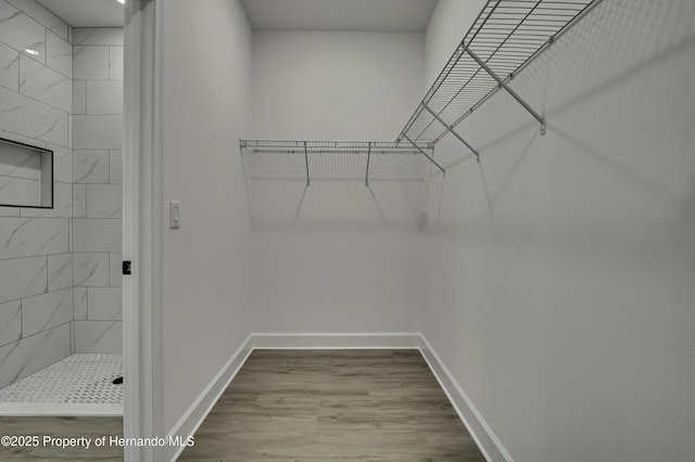 spacious closet with wood finished floors