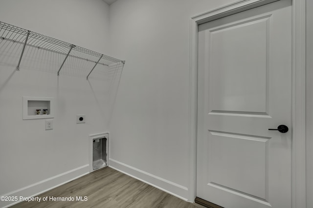 laundry room featuring washer hookup, laundry area, electric dryer hookup, wood finished floors, and baseboards