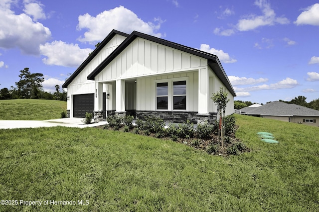 modern farmhouse with board and batten siding, an attached garage, driveway, and a front lawn