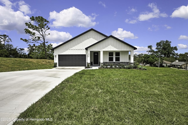 view of front of home featuring board and batten siding, an attached garage, driveway, and a front lawn