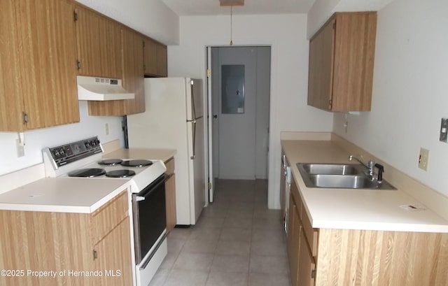 kitchen with white appliances, light countertops, under cabinet range hood, a sink, and light tile patterned floors