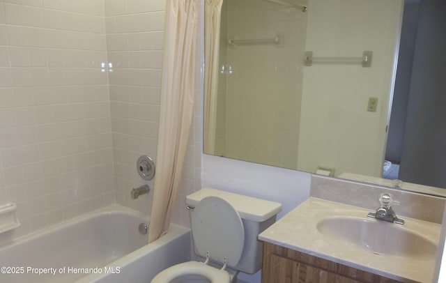 bathroom with vanity, shower / tub combo with curtain, and toilet