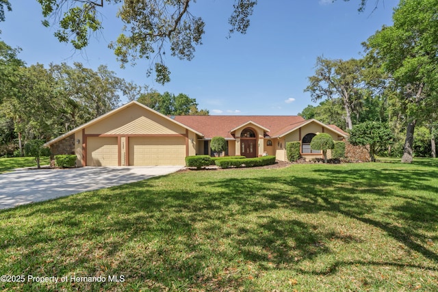7353 Dogwood, Spring Hill, FL 34607 - view of front facade with stucco siding, concrete driveway, a garage, and a front lawn