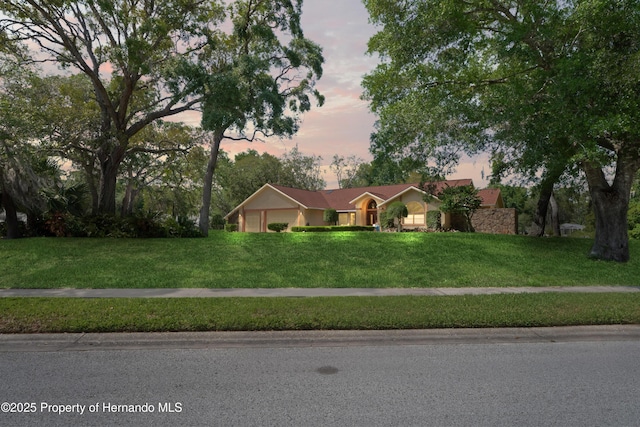7353 Dogwood, Spring Hill, FL 34607 - ranch-style house with an attached garage and a lawn
