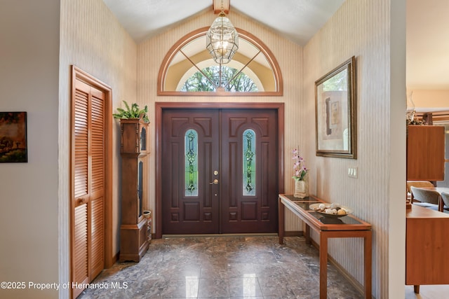 7353 Dogwood, Spring Hill, FL 34607 - entryway featuring baseboards, a notable chandelier, wallpapered walls, and vaulted ceiling with beams