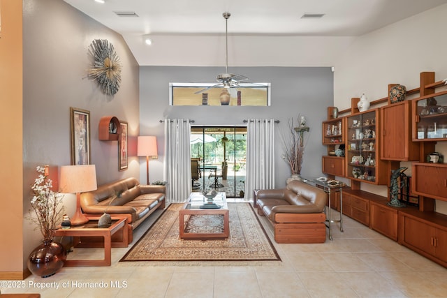 7353 Dogwood, Spring Hill, FL 34607 - living area featuring light tile patterned flooring, visible vents, a ceiling fan, and high vaulted ceiling