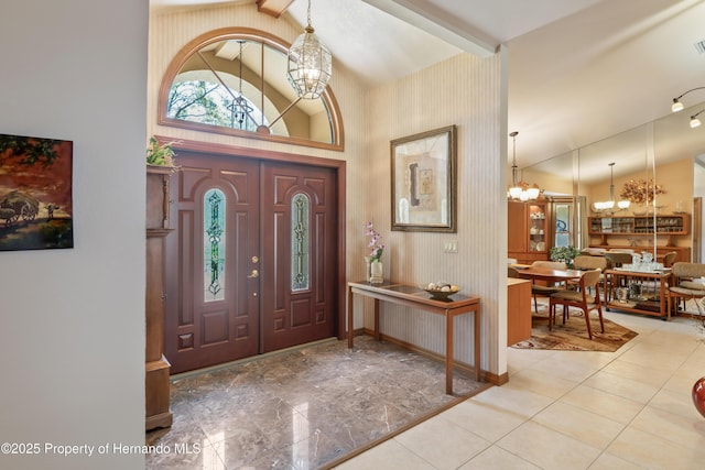 7353 Dogwood, Spring Hill, FL 34607 - tiled foyer with baseboards, an inviting chandelier, visible vents, and vaulted ceiling with beams