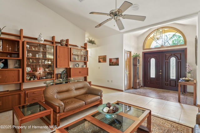 7353 Dogwood, Spring Hill, FL 34607 - living area with light tile patterned floors, baseboards, ceiling fan with notable chandelier, and high vaulted ceiling
