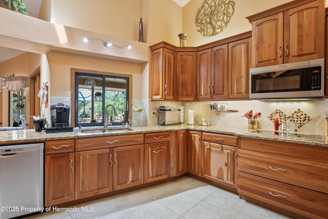7353 Dogwood, Spring Hill, FL 34607 - kitchen featuring light tile patterned floors, stainless steel appliances, decorative backsplash, and a sink
