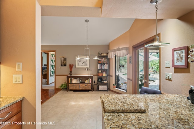 7353 Dogwood, Spring Hill, FL 34607 - living area with lofted ceiling, light tile patterned flooring, and a textured wall