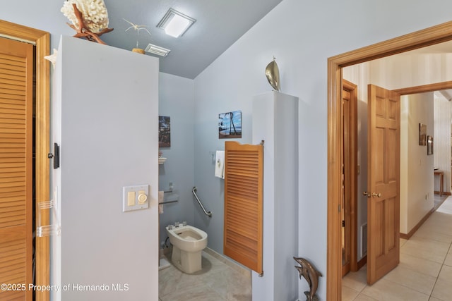7353 Dogwood, Spring Hill, FL 34607 - bathroom with vaulted ceiling, a bidet, visible vents, and tile patterned flooring