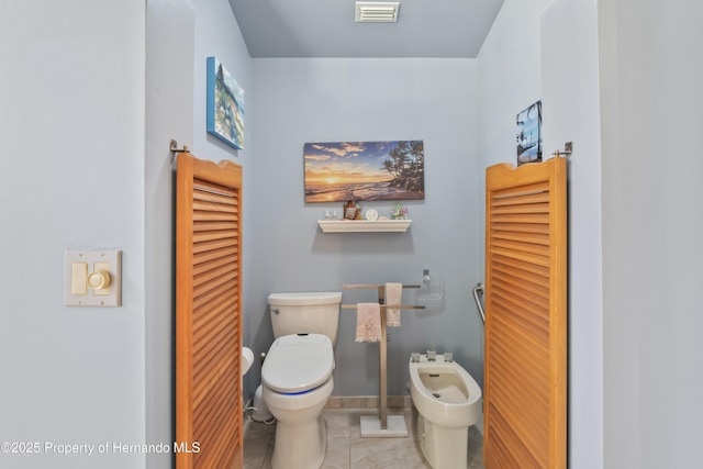 7353 Dogwood, Spring Hill, FL 34607 - bathroom featuring a bidet, toilet, visible vents, and tile patterned flooring