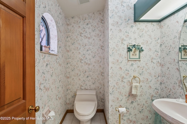7353 Dogwood, Spring Hill, FL 34607 - bathroom featuring toilet, visible vents, tile patterned flooring, and baseboards