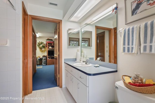 7353 Dogwood, Spring Hill, FL 34607 - bathroom featuring toilet, visible vents, tile patterned flooring, and vanity