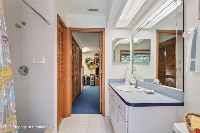 7353 Dogwood, Spring Hill, FL 34607 - bathroom with toilet, visible vents, a tile shower, tile patterned floors, and vanity