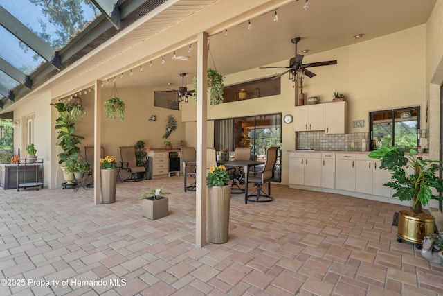 7353 Dogwood, Spring Hill, FL 34607 - view of patio / terrace with an outdoor kitchen, a ceiling fan, and glass enclosure