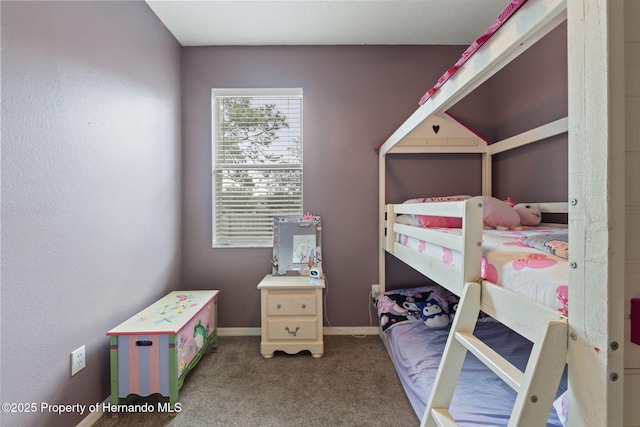 bedroom featuring baseboards and carpet flooring