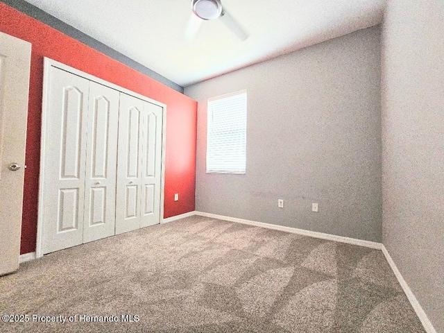 4214 Canongate Ct, Spring Hill, FL 34609 - unfurnished bedroom with carpet, a closet, and a ceiling fan