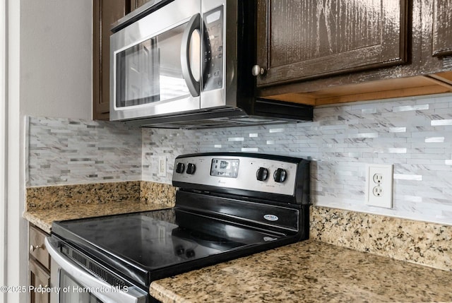 6440 Curtiss Ln, Spring Hill, FL 34608 - kitchen featuring appliances with stainless steel finishes, dark brown cabinets, backsplash, and light stone counters