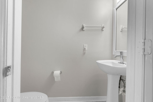 6440 Curtiss Ln, Spring Hill, FL 34608 - half bathroom featuring toilet and baseboards