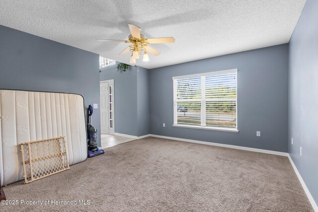 6440 Curtiss Ln, Spring Hill, FL 34608 - carpeted empty room with a ceiling fan, a textured ceiling, and baseboards