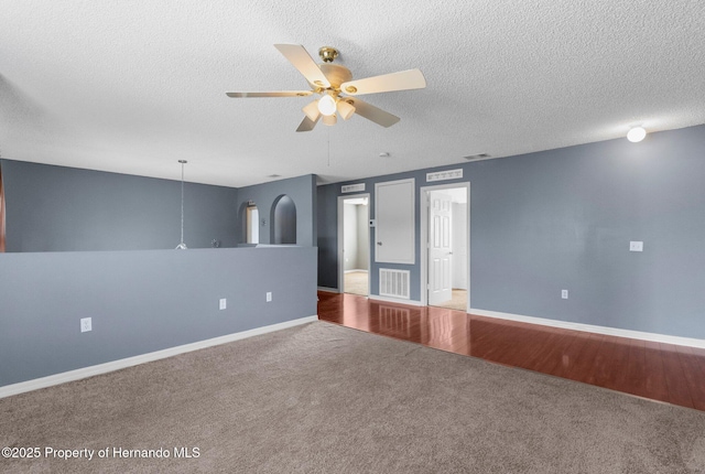 6440 Curtiss Ln, Spring Hill, FL 34608 - carpeted empty room with a ceiling fan, a textured ceiling, and baseboards