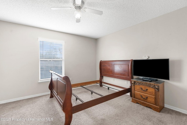 6440 Curtiss Ln, Spring Hill, FL 34608 - bedroom with light carpet, a textured ceiling, baseboards, and ceiling fan