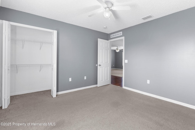 6440 Curtiss Ln, Spring Hill, FL 34608 - unfurnished bedroom with carpet, a closet, baseboards, ceiling fan, and a textured ceiling