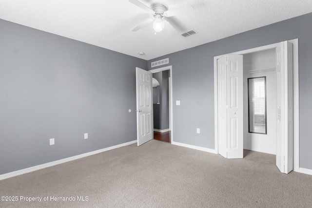 6440 Curtiss Ln, Spring Hill, FL 34608 - unfurnished bedroom featuring carpet, a textured ceiling, baseboards, a closet, and ceiling fan
