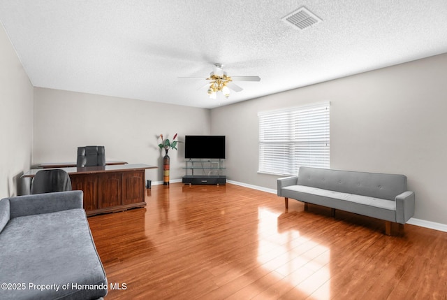 6440 Curtiss Ln, Spring Hill, FL 34608 - office area with a ceiling fan, light wood-style floors, a textured ceiling, and baseboards