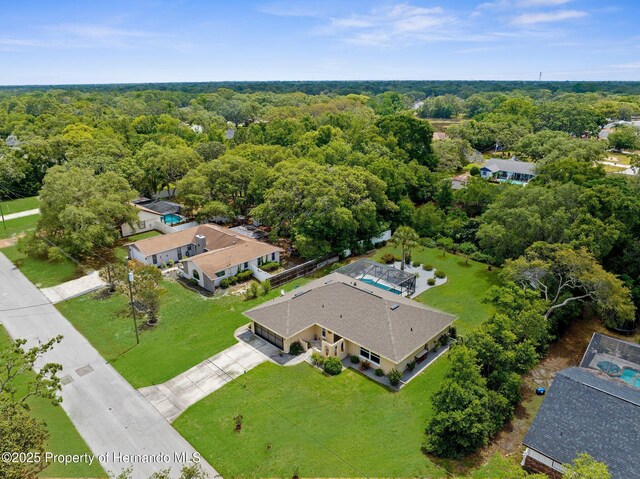 birds eye view of property with a forest view